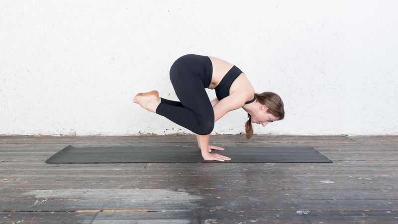 Premium Photo | Woman practicing yoga doing bakasana exercise or crane pose